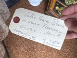 a person holding a note with a plant in it