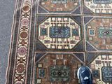 a person standing on a rug that has a pattern on it
