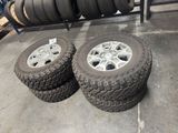 tires are stacked on a rack in a warehouse with other tires