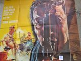 movie poster of a man holding a gun in front of a wall
