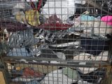 a metal cage filled with many different types of shoes