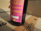 a bottle of wine sitting on top of a cardboard box