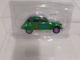 a small green toy car in a clear display case