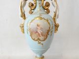a blue vase with a picture of a woman on it