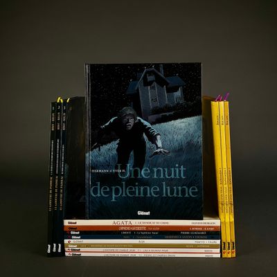 books are stacked on top of each other in front of a dark background
