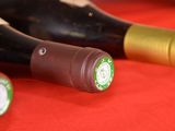 several bottles of wine are lined up on a red table
