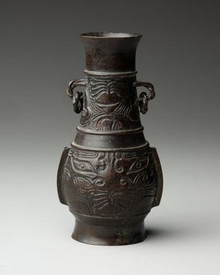 a brown vase that is sitting on a table