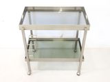 an image of a stainless steel and glass serving cart on wheels