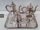 silver plated tea and coffee set on tray on white surface