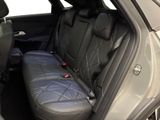 the back seats of a car with a black leather seat cover