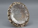 a close up of a silver ring with a picture of a woman on it