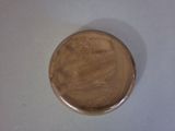 a close up of a small brown object on a white surface