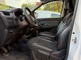 the interior of a car with the door open and the driver ' s seat down