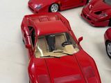 four red toy cars sitting on a white surface