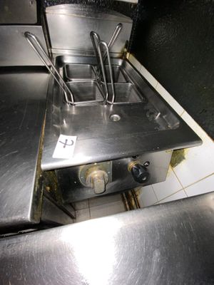 a silver stove top with a bunch of cooking utensils on it