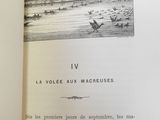 an open book with a drawing of a boat in the water