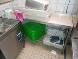 a kitchen with a sink, dishwasher, and other items on the counter