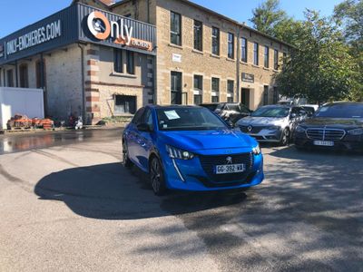 a blue car that is parked in front of a building