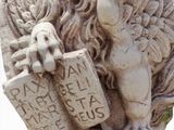 a statue of a lion holding a book and a book