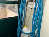 a blue hose attached to a wall next to a window