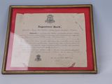 an old document in a wooden frame with a red border