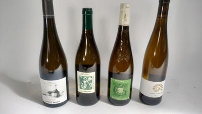 three bottles of wine are lined up on a white surface