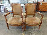 une paire de chaises anciennes avec des assises rembourrées dans une boutique