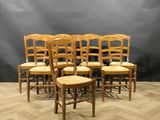 a set of six wooden chairs with rushing seats
