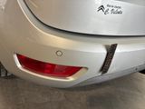 a close up of a silver car in a showroom