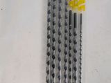 four black and white pencils are lined up on a white surface