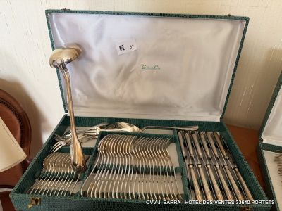 a green case with silverware in it on a table