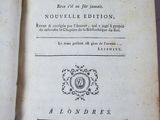 an old book with a black and white cover sitting on top of a table