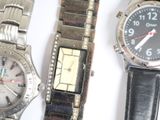 two watches are sitting next to each other on a white surface