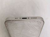 the back of a silver cell phone with a small hole in the middle