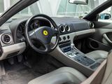 a car dashboard with a steering wheel and dashboard buttons