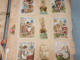two old books with pictures of children on them on a table