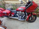 a red motorcycle that is parked next to a orange motorcycle