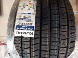 tires on display in a shop with a price tag attached to them