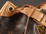 a brown and black purse with a gold buckle