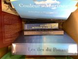 books stacked on top of each other in a cardboard box