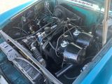 a blue car that has a bunch of wires in it