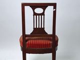 an image of a wooden chair with a red upholstered seat