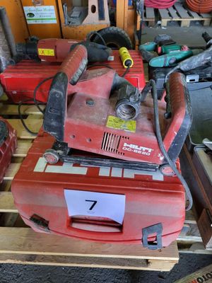 a red machine that is sitting on top of a pallet