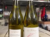 two bottles of wine sitting on a table in a store
