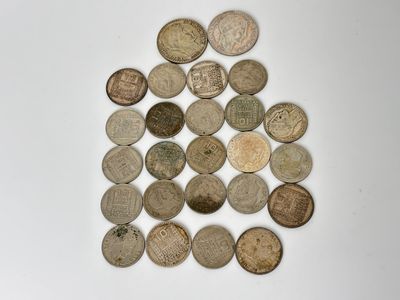 several different types of coins are arranged on a white surface