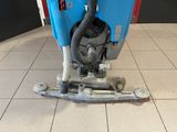 a blue machine that is sitting on a tiled floor