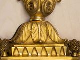 a gold clock with a lion on top of it