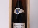 a bottle of wine in a wooden box on a table