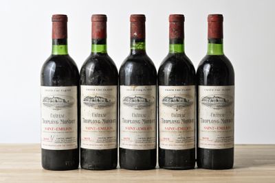 four bottles of wine are lined up on a table