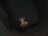 the hat is black and has a gold emblem on it
